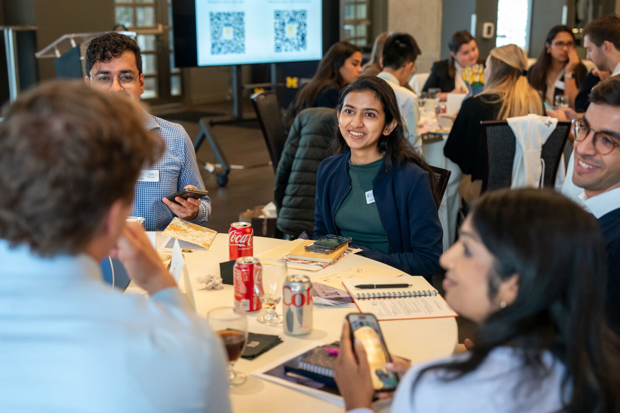 Students talking at the Ross Leaders Academy Kickoff event at Zingerman’s Greyline in Ann Arbor, MI on October 25, 2024. AP Style